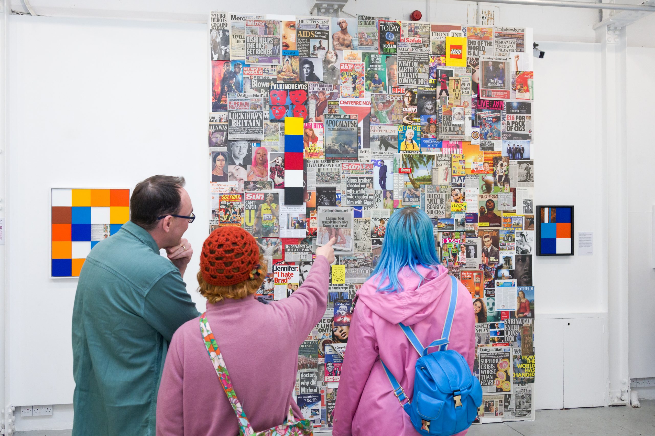 People looking at and discussing original artwork installation with Stephen Tribbel at his 2024 exhibition at Centrespace Gallery, Bristol, UK. This Is Our World site-specific temporary installation.